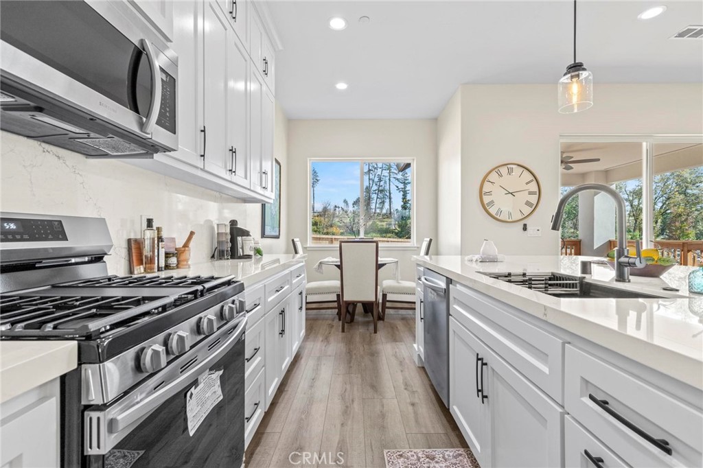 6148 Ripley Lane Paradise, CA 95969 - Photo 14 of 37 a kitchen with stainless steel appliances a stove sink and cabinets