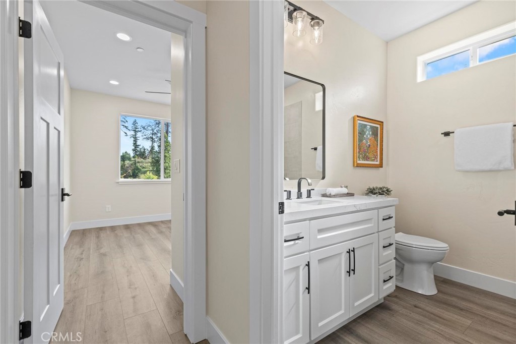 6148 Ripley Lane Paradise, CA 95969 - Photo 17 of 37 a bathroom with a granite countertop toilet a sink and a mirror
