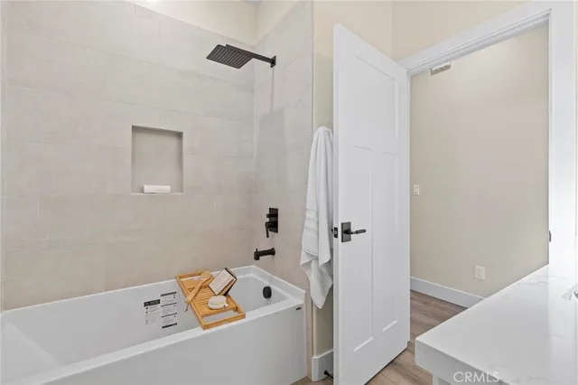 an empty room with a window and a ceiling fan