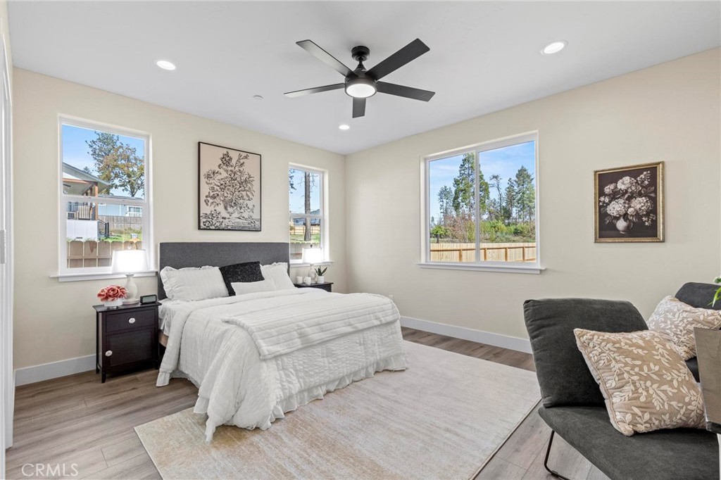 6148 Ripley Lane Paradise, CA 95969 - Photo 24 of 37 a bedroom with a large bed and a couch