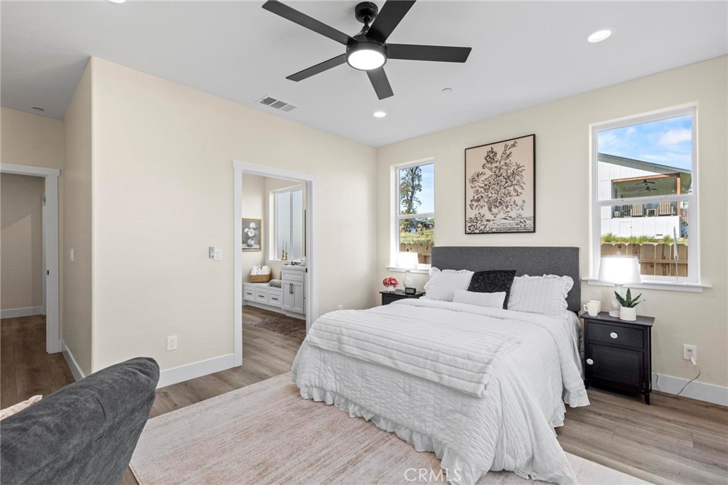 6148 Ripley Lane Paradise, CA 95969 - Photo 25 of 37 a bedroom with a bed and a chandelier