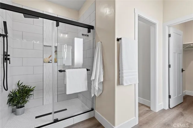 a bathroom with a toilet and a shower