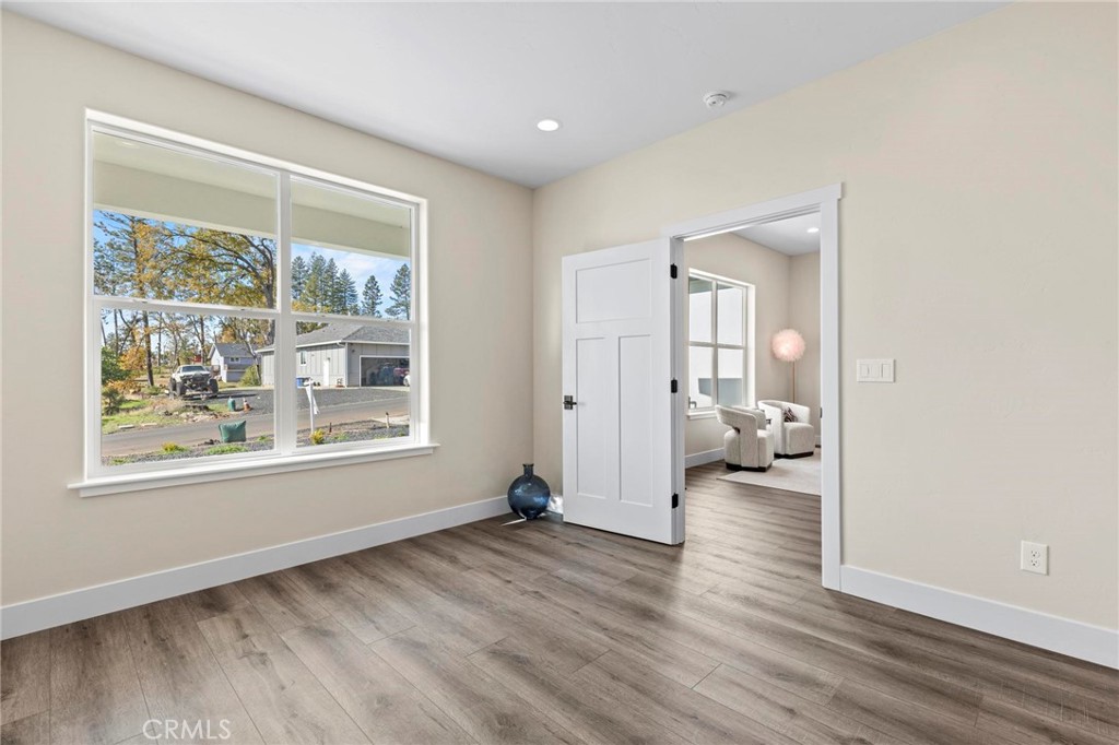 6148 Ripley Lane Paradise, CA 95969 - Photo 8 of 37 a view of a livingroom with wooden floor and a bedroom