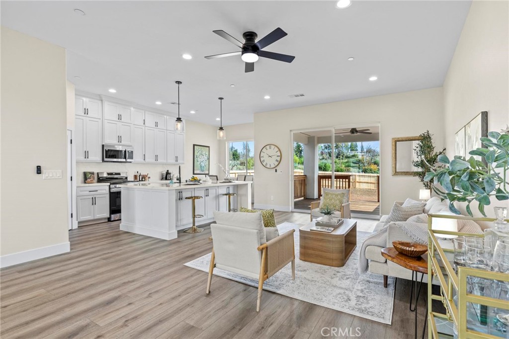 6148 Ripley Lane Paradise, CA 95969 - Photo 9 of 37 a living room with furniture kitchen area and a wooden floor