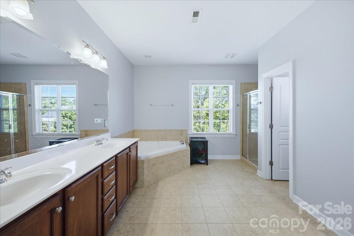 1825 Laveta Road Charlotte, NC 28269 - Photo 20 of 48 a spacious bathroom with a tub sink and mirror