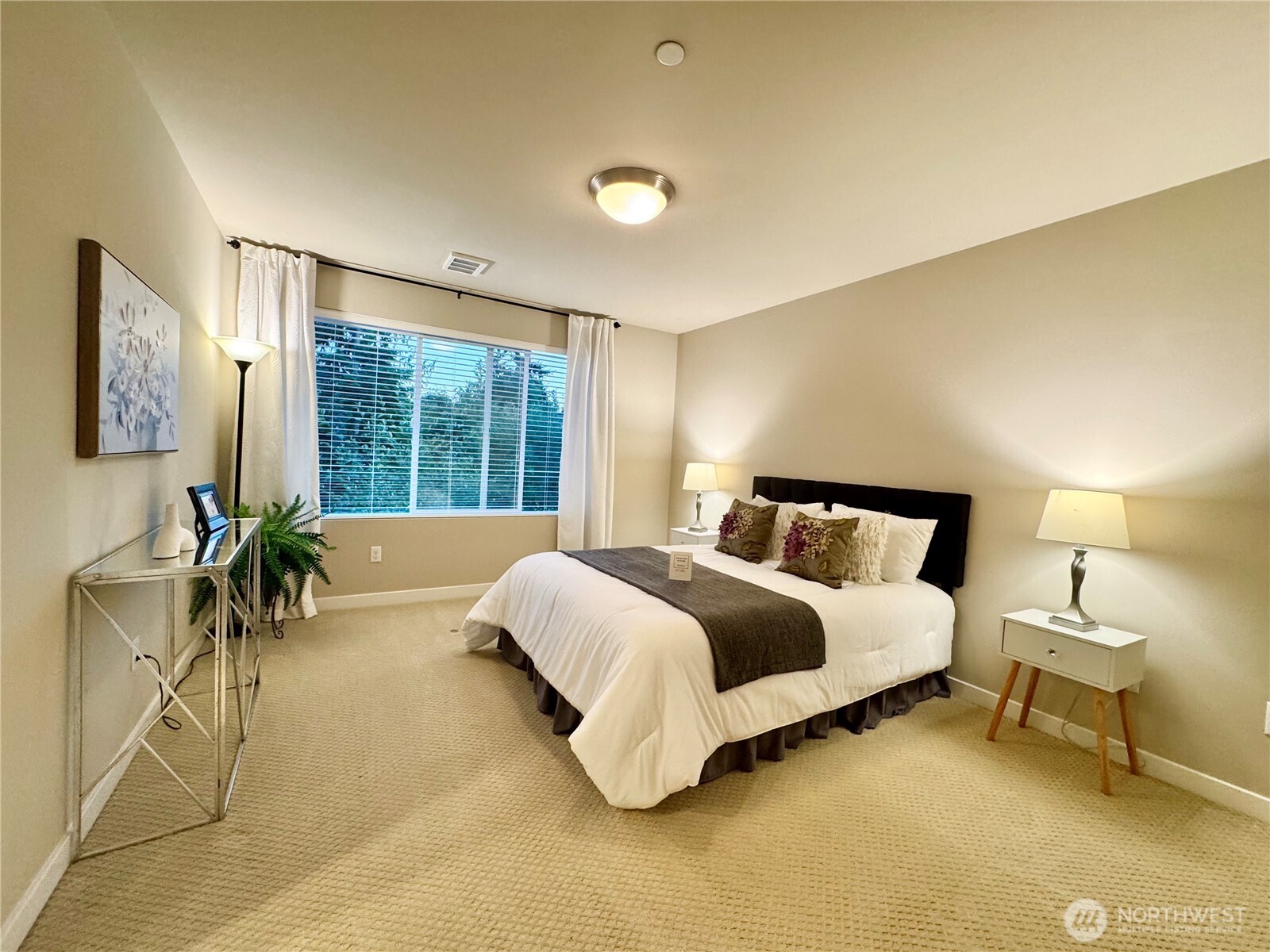 1928 78th Place Southeast Everett, WA 98203 - Photo 16 of 39 a spacious bedroom with a bed and a table