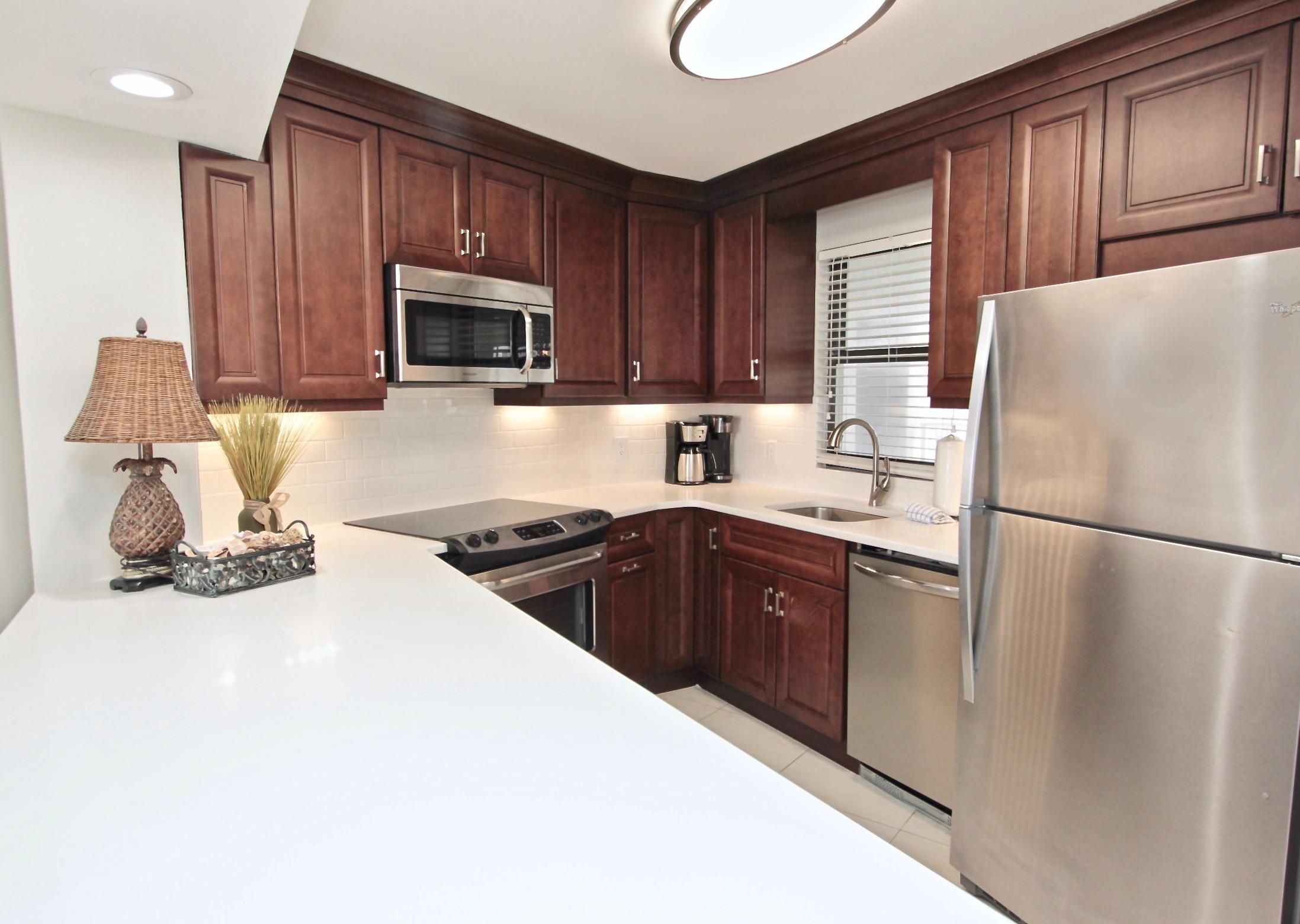 4239 Beachside 2, Unit 239 Miramar Beach, FL 32550 - Photo 11 of 18 a kitchen with a refrigerator stove top oven a sink and dishwasher