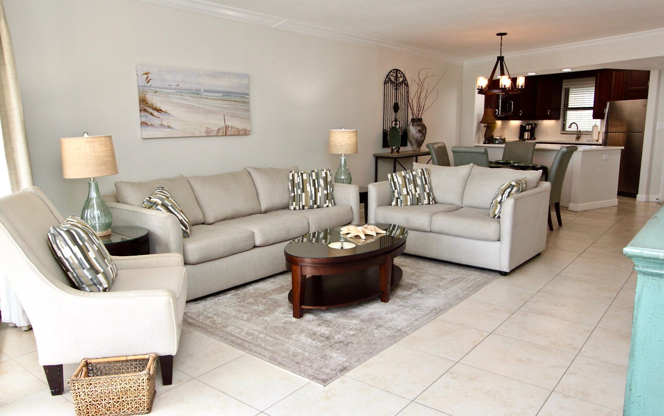 4239 Beachside 2, Unit 239 Miramar Beach, FL 32550 - Photo 8 of 18 a living room with furniture and a chandelier