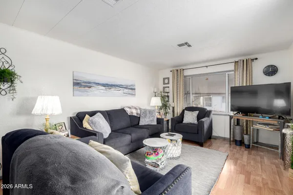 a living room with furniture and a flat screen tv