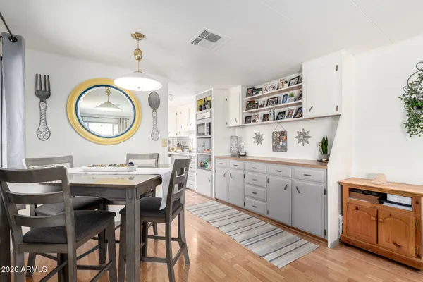 a kitchen with a sink a stove and chairs