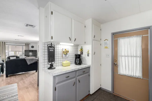 a view of kitchen with refrigerator and window