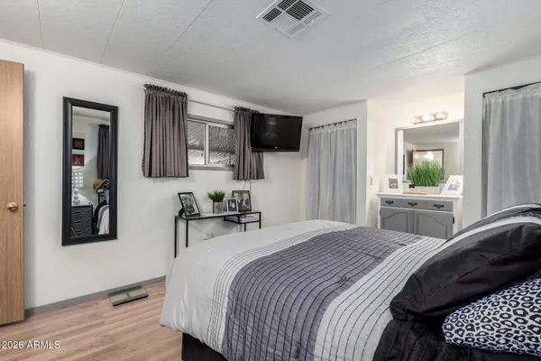 a bedroom with a bed a window and a television