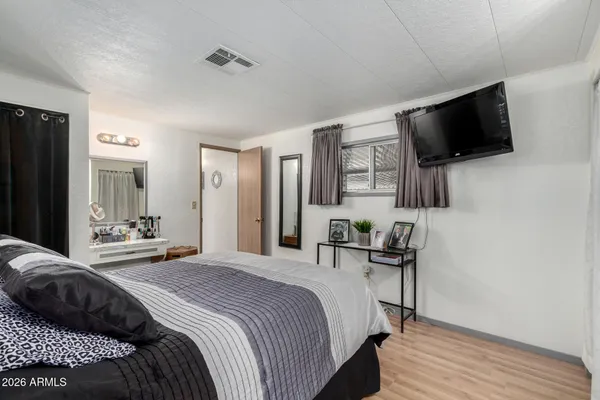 a bedroom with a bed and a flat screen tv