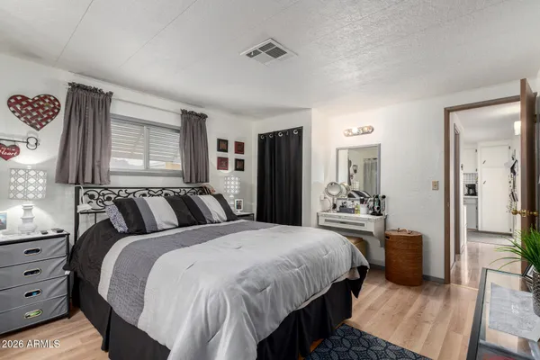 a bedroom with a bed and a dresser