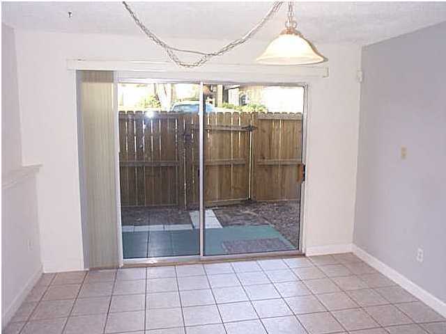 210 Pelham Road, Unit C120 Fort Walton Beach, FL 32547 - Photo 4 of 11 a view of a room with sliding glass door