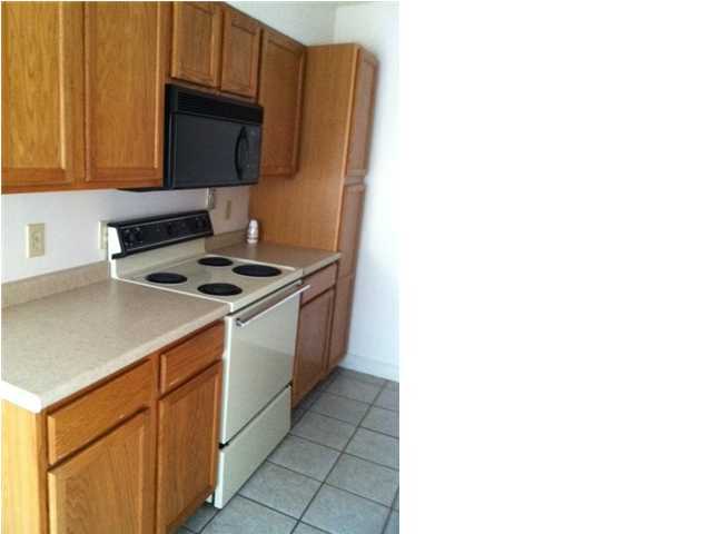210 Pelham Road, Unit C120 Fort Walton Beach, FL 32547 - Photo 5 of 11 a kitchen with stainless steel appliances granite countertop a sink and a stove