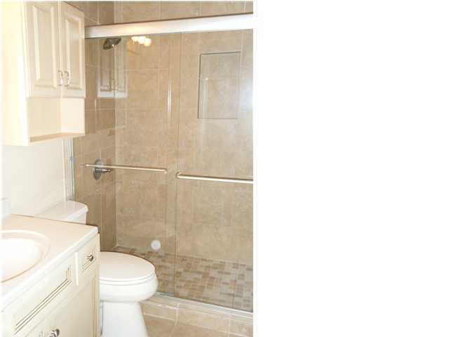 210 Pelham Road, Unit C120 Fort Walton Beach, FL 32547 - Photo 7 of 11 a bathroom with a shower a toilet and a sink