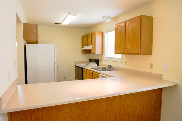 a kitchen with a sink a stove and a refrigerator