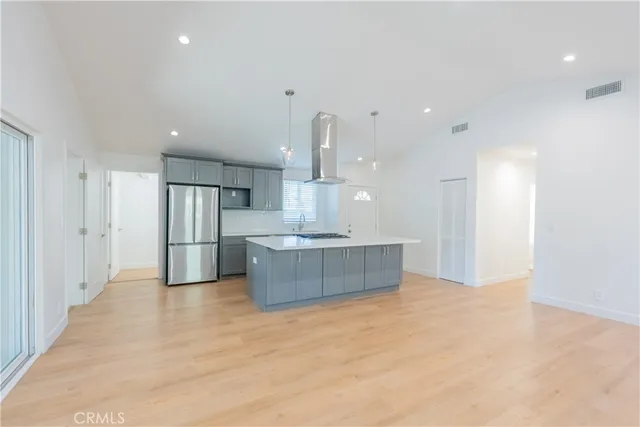 a view of kitchen with refrigerator sink and wooden floor