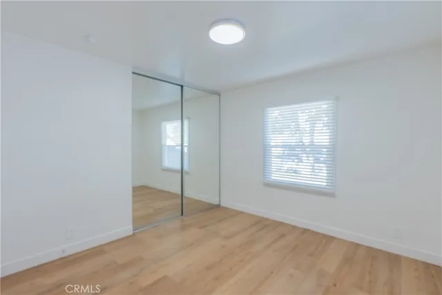a bathroom with a granite countertop sink a toilet and a window