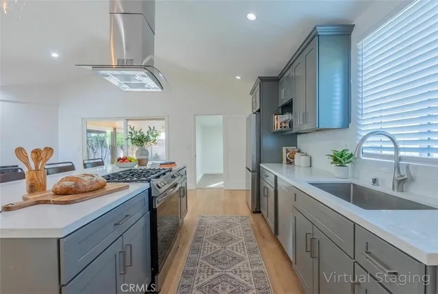 a kitchen with stainless steel appliances granite countertop a sink and stove
