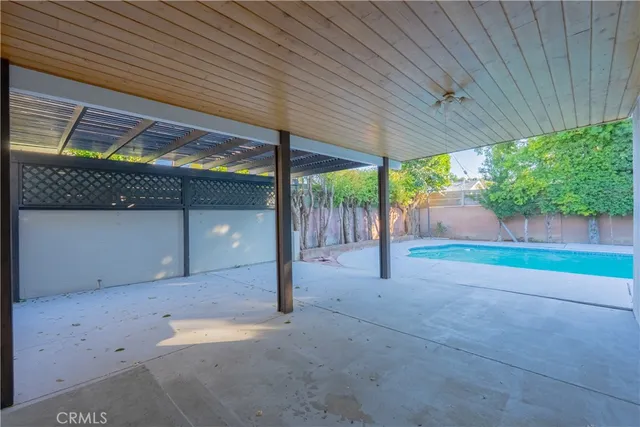 a view of a house with pool and chairs