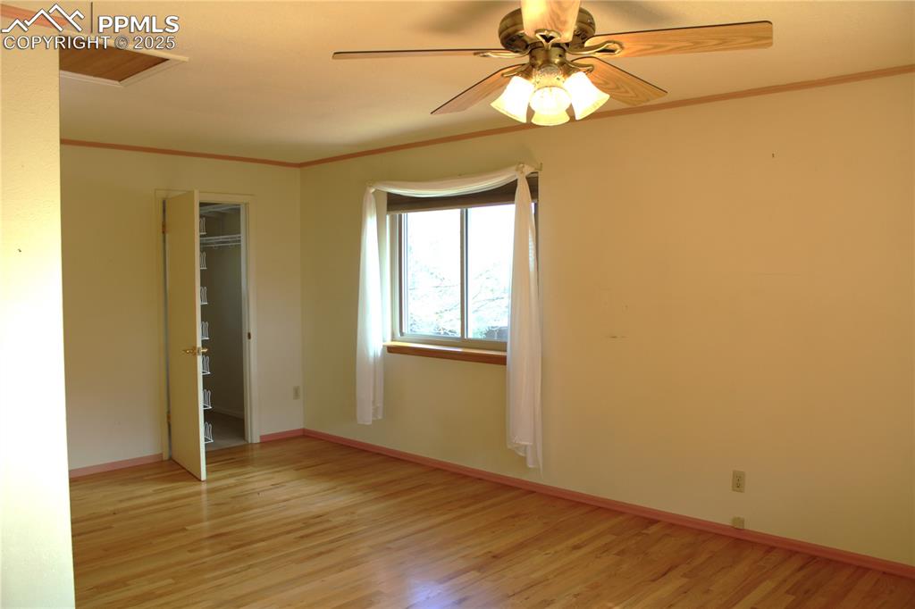 8340 Piute Road Colorado Springs, CO 80926 - Photo 24 of 48 wooden floor in an empty room with a window