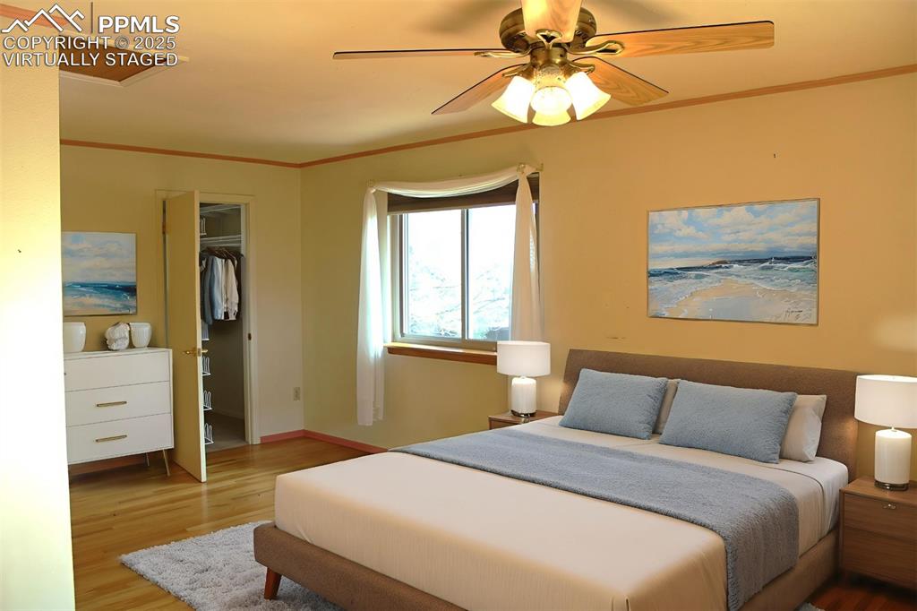 8340 Piute Road Colorado Springs, CO 80926 - Photo 25 of 48 a bedroom with a bed and a chandelier