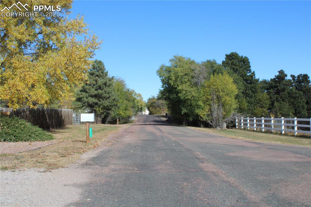 8340 Piute Road Colorado Springs, CO 80926 - Photo 3 of 48 a view of a road with a yard