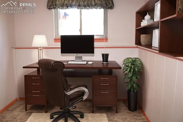 a view of a small space with wooden floor and a window