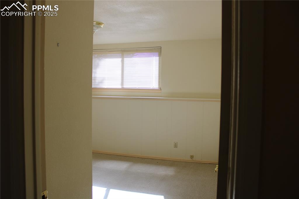 8340 Piute Road Colorado Springs, CO 80926 - Photo 32 of 48 a view of a small space with wooden floor and a window