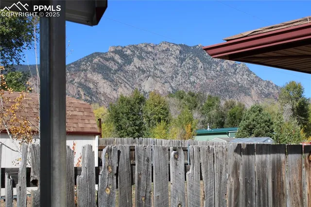 a view of a backyard with wooden fence and wooden fence