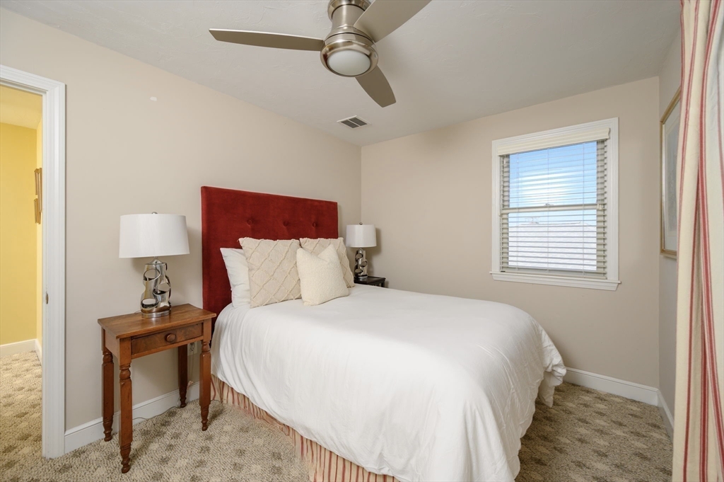 76 Wyola Road Hull, MA 02045 - Photo 16 of 28 a bedroom with a bed and a night stand