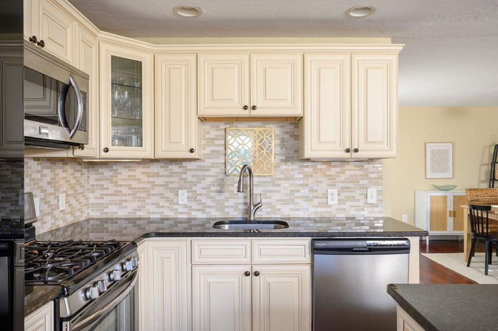 76 Wyola Road Hull, MA 02045 - Photo 5 of 28 a kitchen with stainless steel appliances granite countertop a sink stove and cabinets