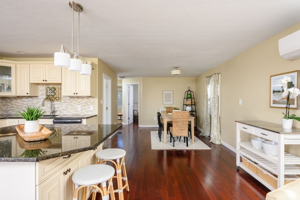 76 Wyola Road Hull, MA 02045 - Photo 6 of 28 a living room with dining table furniture and a chandelier