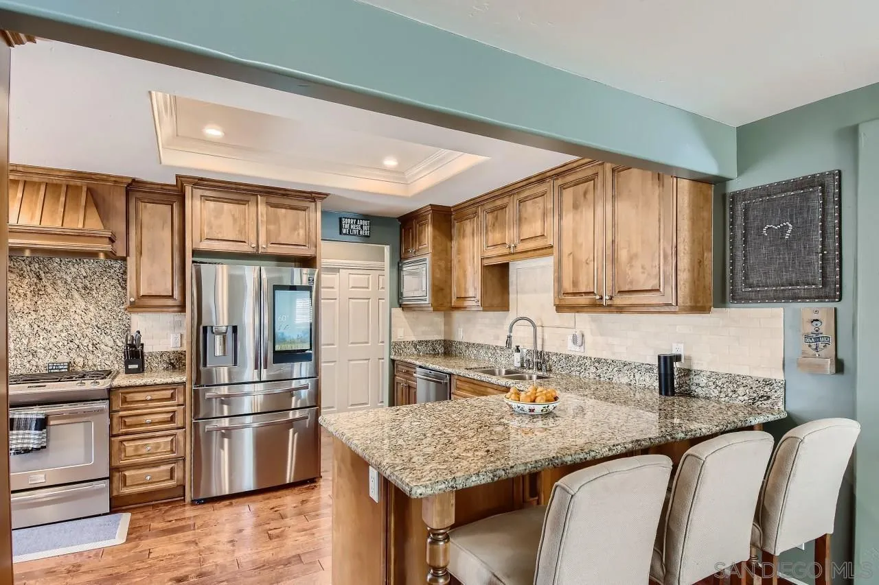 10023 Carreta Drive Santee, CA 92071 - Photo 12 of 24 a kitchen with granite countertop a sink stove and refrigerator