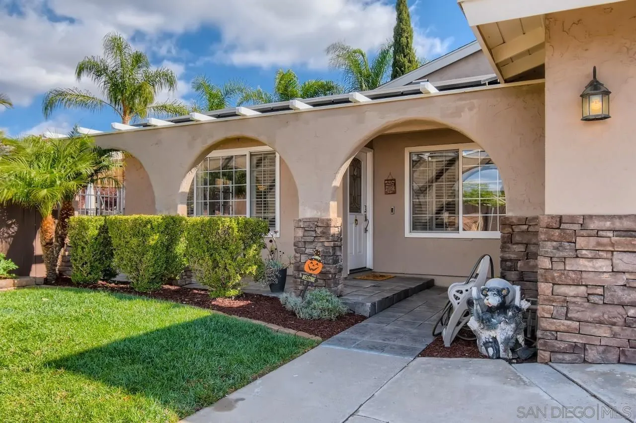 10023 Carreta Drive Santee, CA 92071 - Photo 3 of 24 a front view of a house with garden