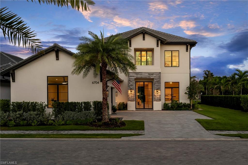 6704 Newport Road Naples, FL 34109 - Photo 2 of 47 a front view of a house with a yard and garage