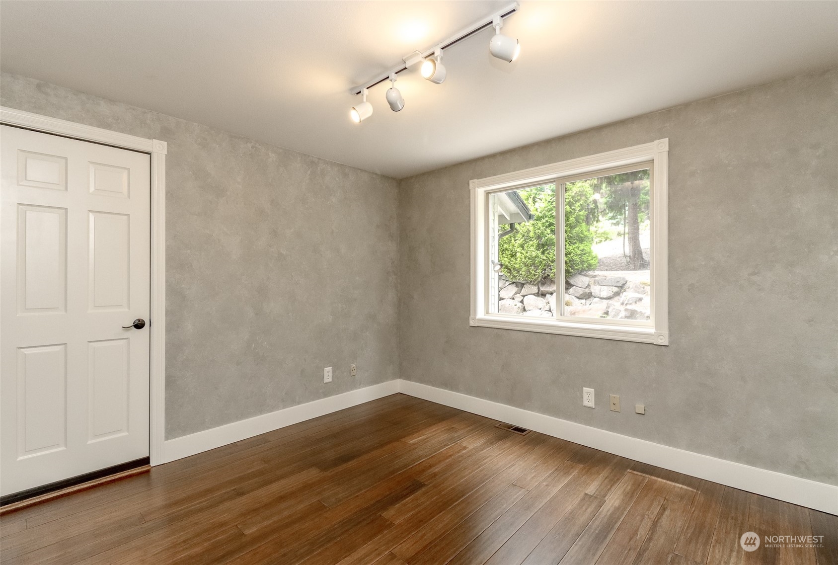 16918 Southeast 149th Street Renton, WA 98059 - Photo 16 of 40 an empty room with wooden floor and windows