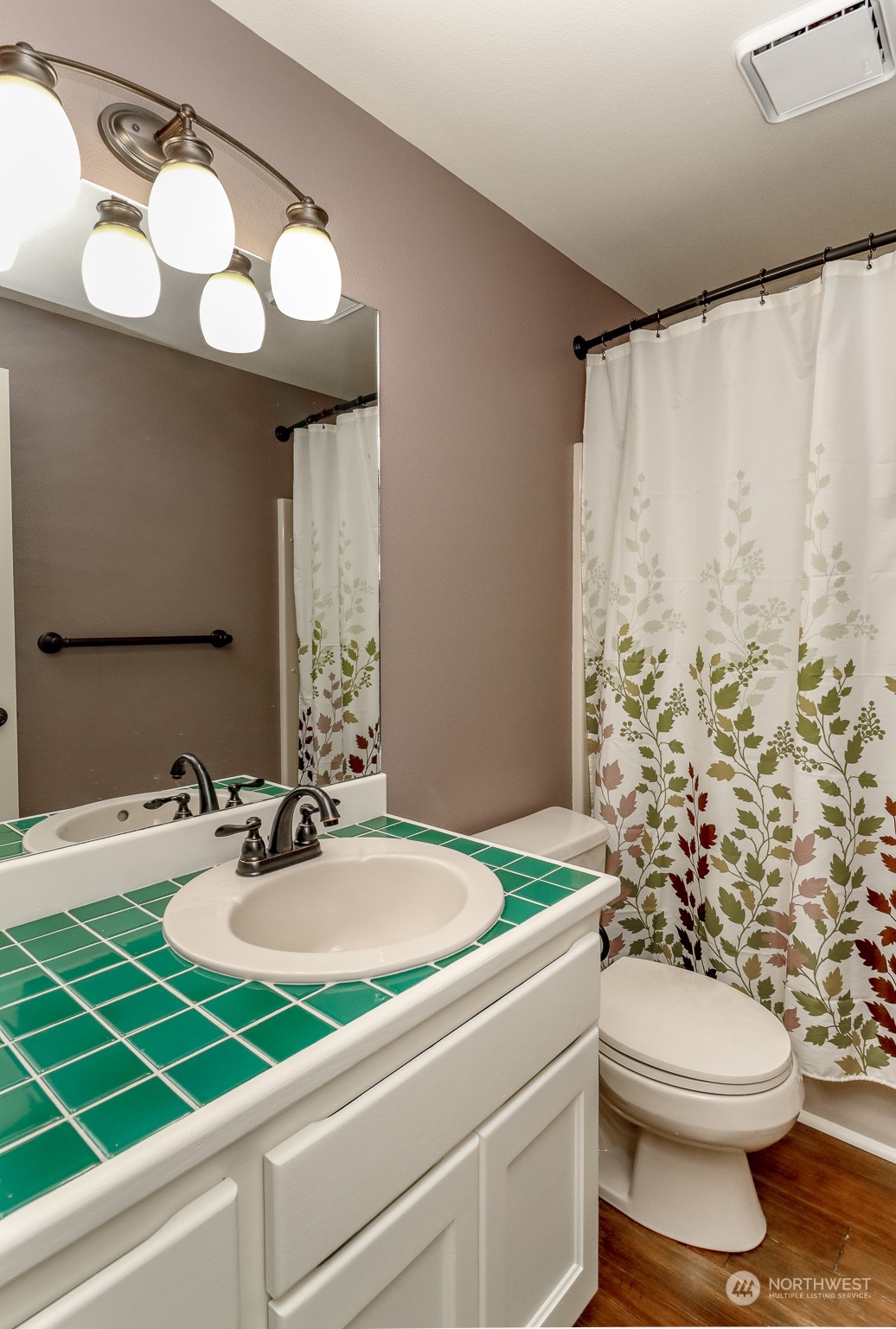 16918 Southeast 149th Street Renton, WA 98059 - Photo 18 of 40 a bathroom with a sink a toilet and a mirror