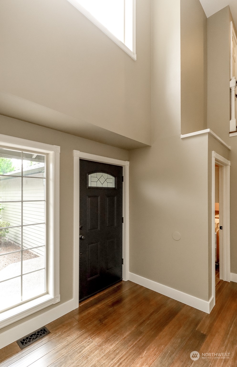 16918 Southeast 149th Street Renton, WA 98059 - Photo 3 of 40 an empty room with wooden floor closet and windows