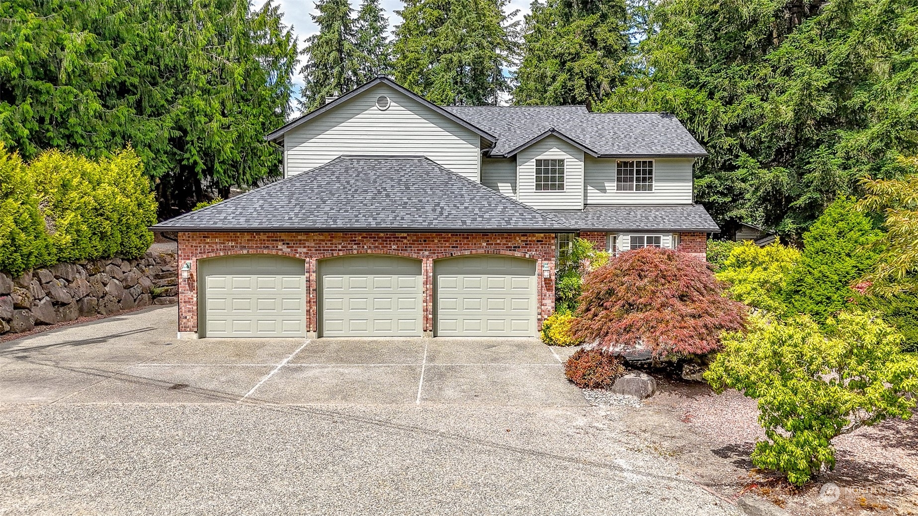 16918 Southeast 149th Street Renton, WA 98059 - Photo 36 of 40 a front view of a house with a garden and garage