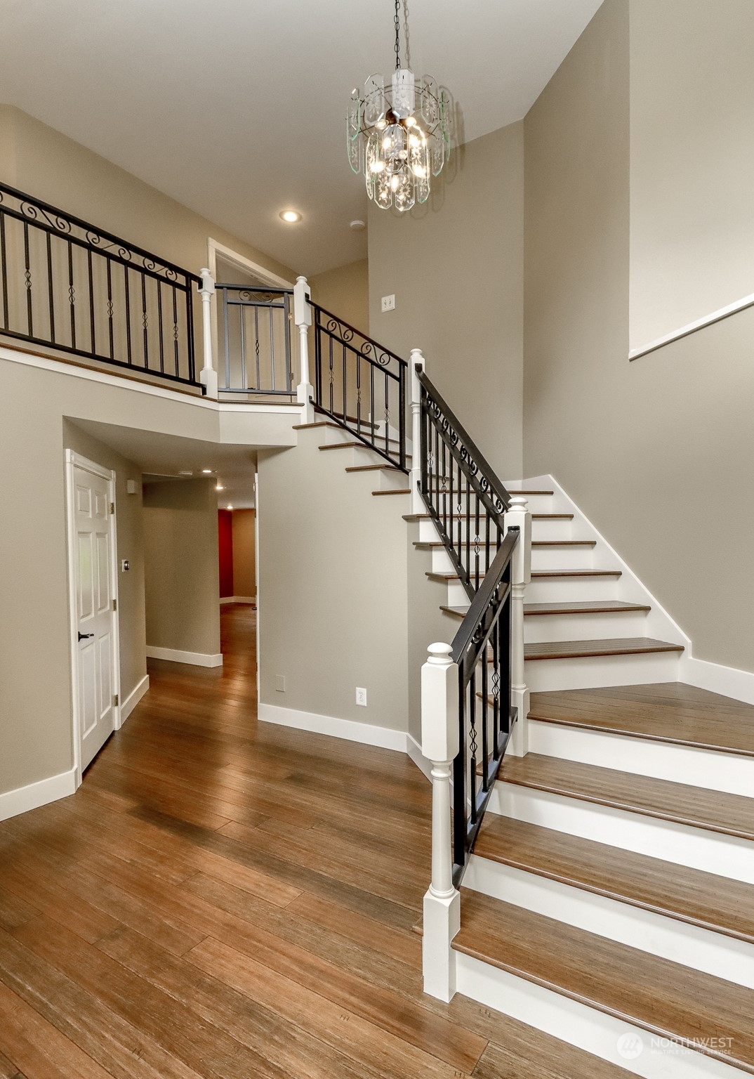 16918 Southeast 149th Street Renton, WA 98059 - Photo 4 of 40 a view of staircase with white walls and chandelier