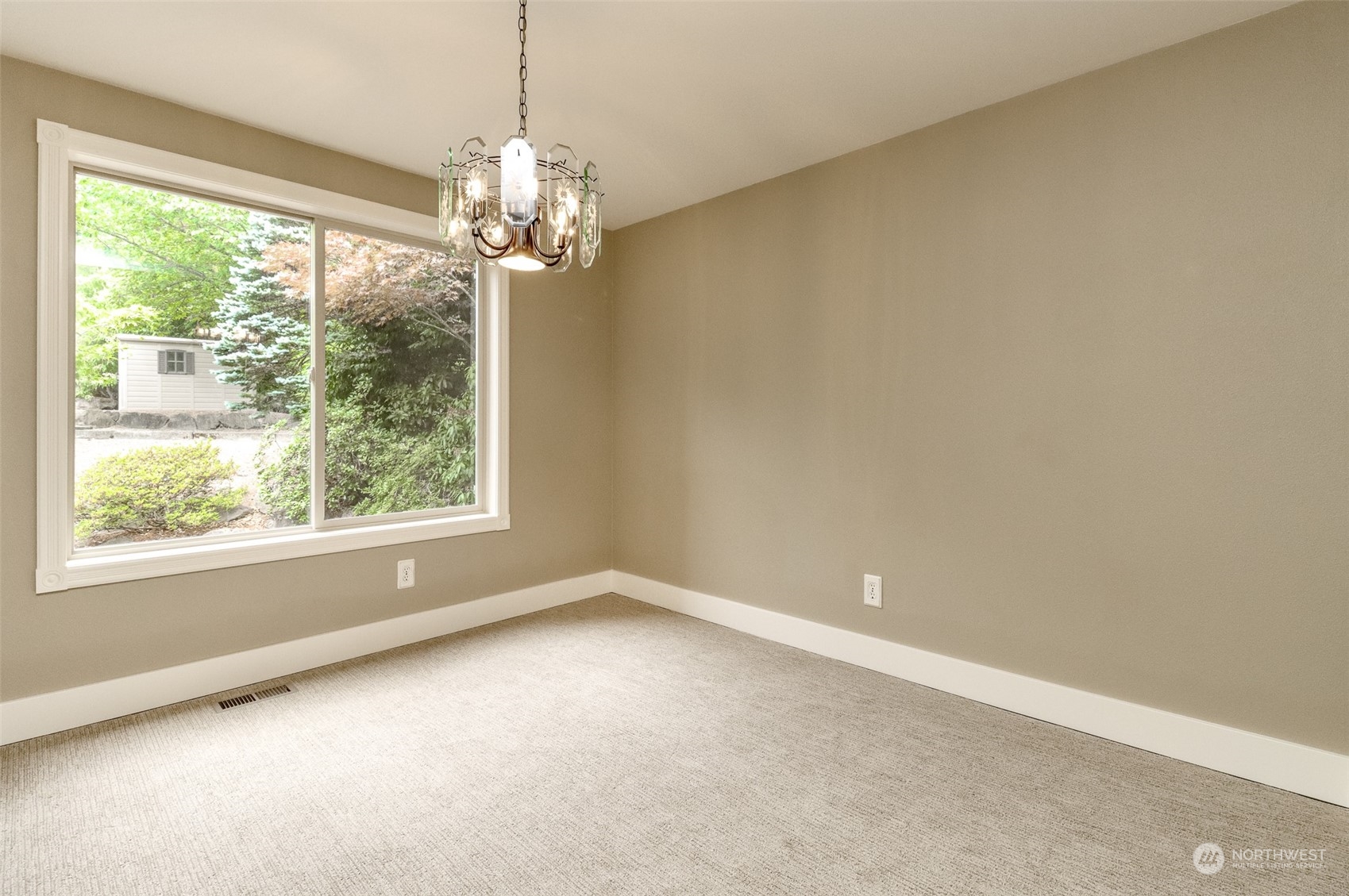 16918 Southeast 149th Street Renton, WA 98059 - Photo 7 of 40 en empty room with windows and chandelier