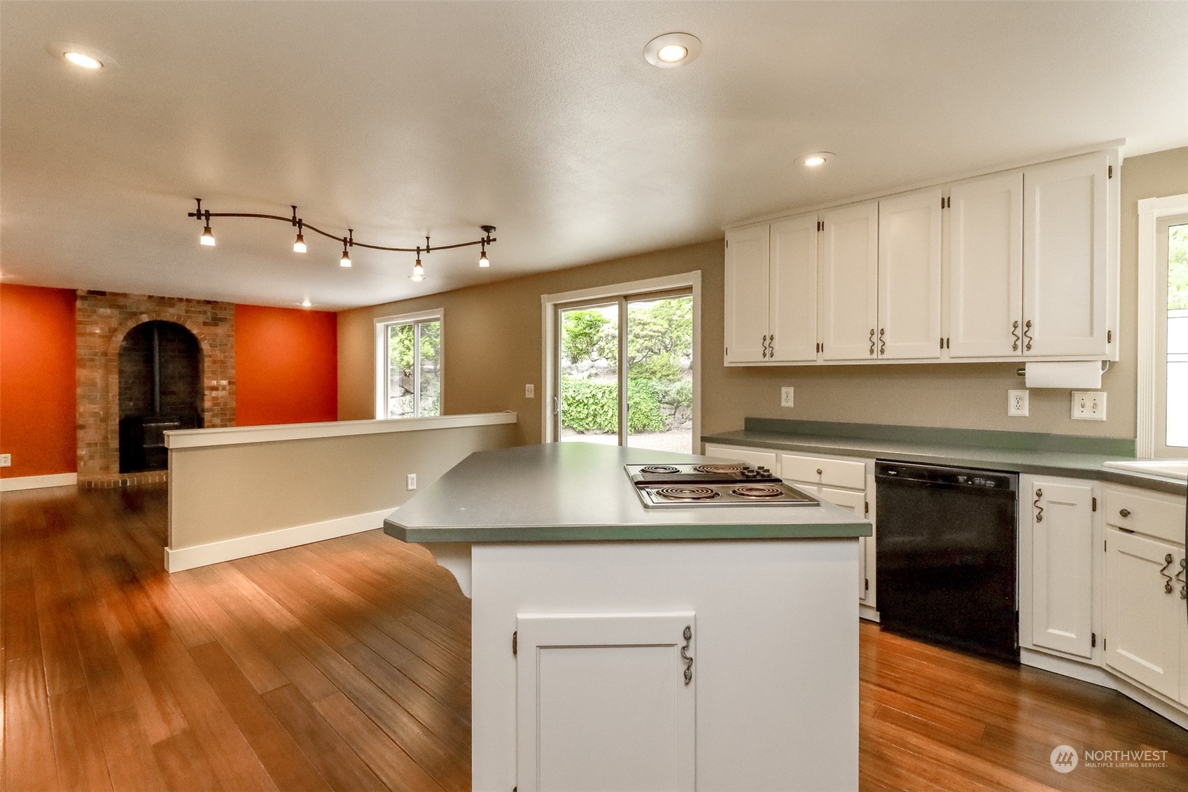 16918 Southeast 149th Street Renton, WA 98059 - Photo 9 of 40 a kitchen with kitchen island granite countertop a sink cabinets and stainless steel appliances