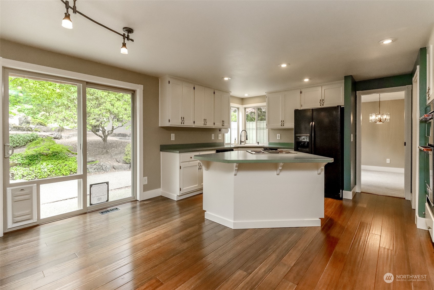 16918 Southeast 149th Street Renton, WA 98059 - Photo 10 of 40 a view of a kitchen with wooden floor and a window