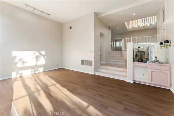 a view of empty room with wooden floor