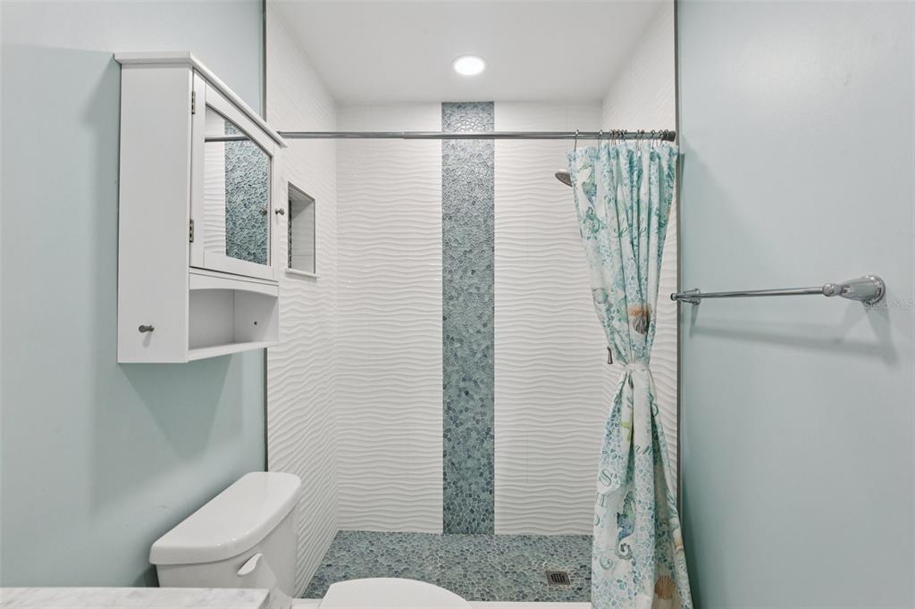 14800 Walsingham Road, Unit 1215 Largo, FL 33774 - Photo 14 of 34 a bathroom with a shower toilet and sink