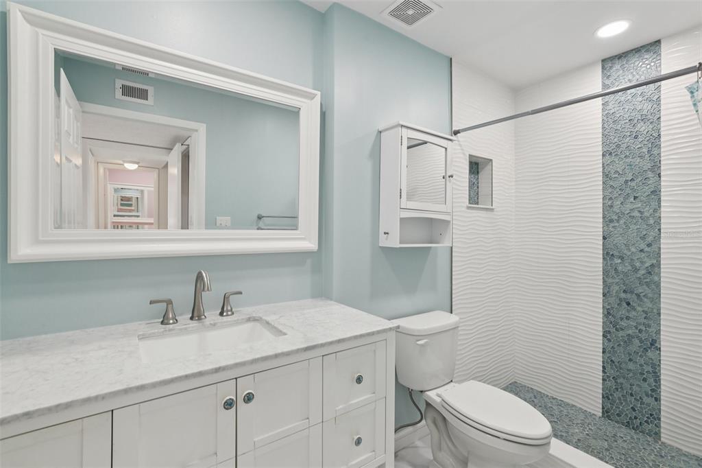 14800 Walsingham Road, Unit 1215 Largo, FL 33774 - Photo 15 of 34 a bathroom with a sink a toilet and shower