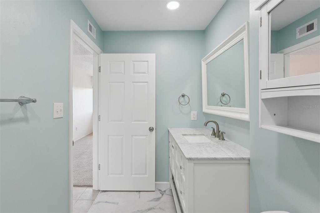 14800 Walsingham Road, Unit 1215 Largo, FL 33774 - Photo 16 of 34 a bathroom with a sink and a mirror
